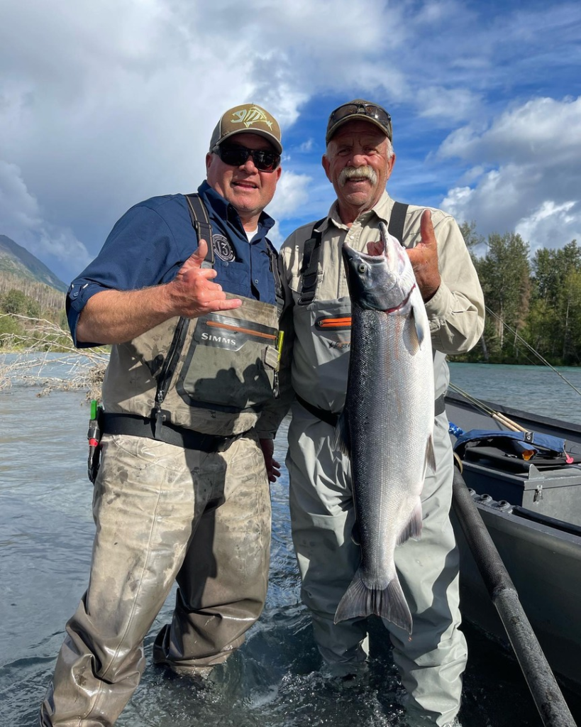 an angler and fishing guide Jason Lesmeister holding a majestic silver salmon on the Kenai River