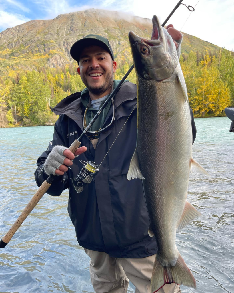 an angler holding silver salmon on the Kenai River