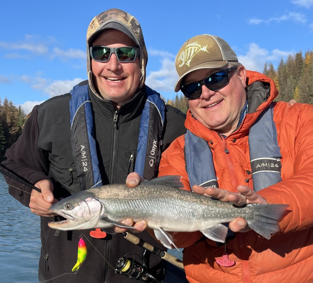 anglers holding Dolly Varden char on the Kenai River