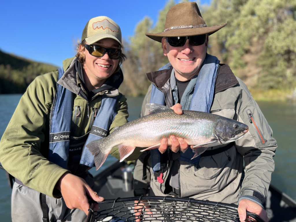 anglers holding Dolly Varden char on the Kenai River