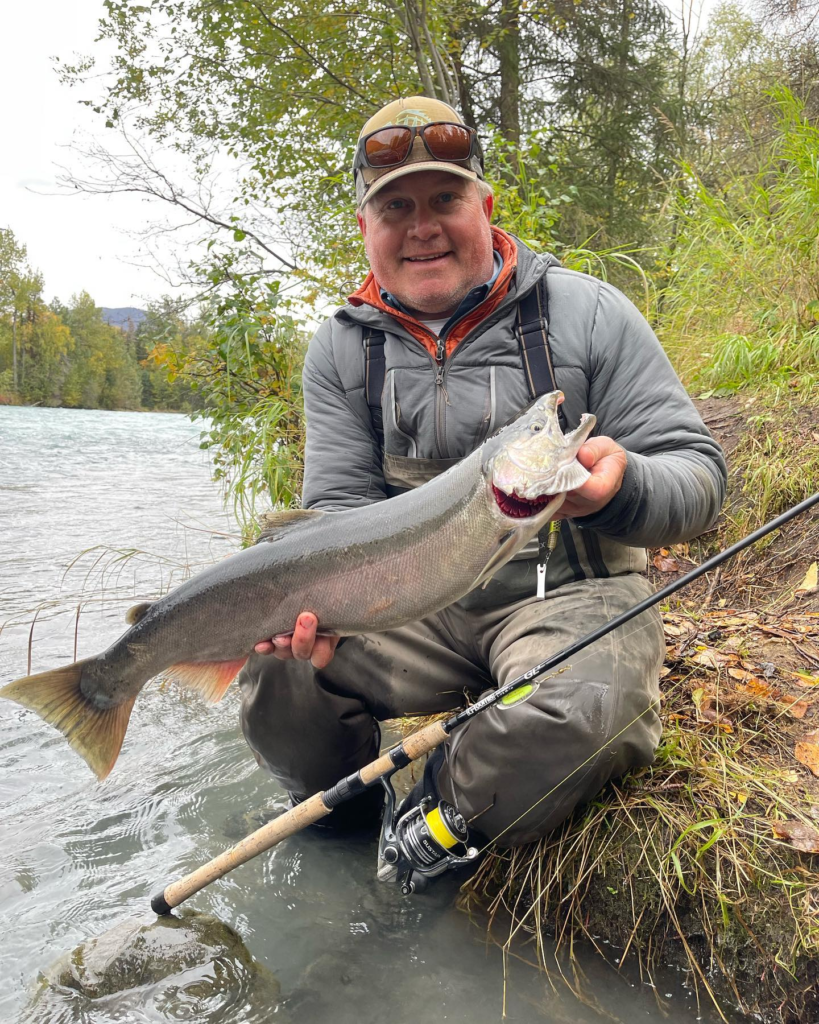 fishing guide Jason Lesmeister holding silver salmon on the Kenai River