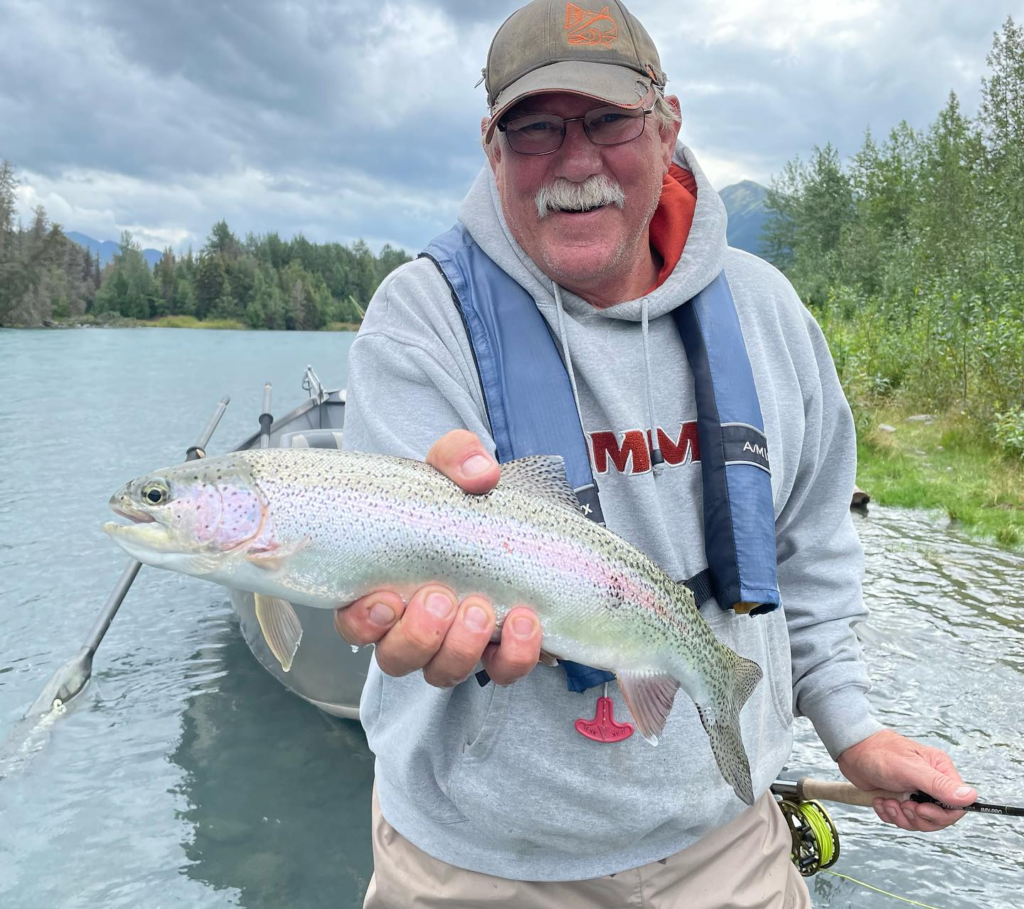an angler holding rainbow trout on the Kenai River