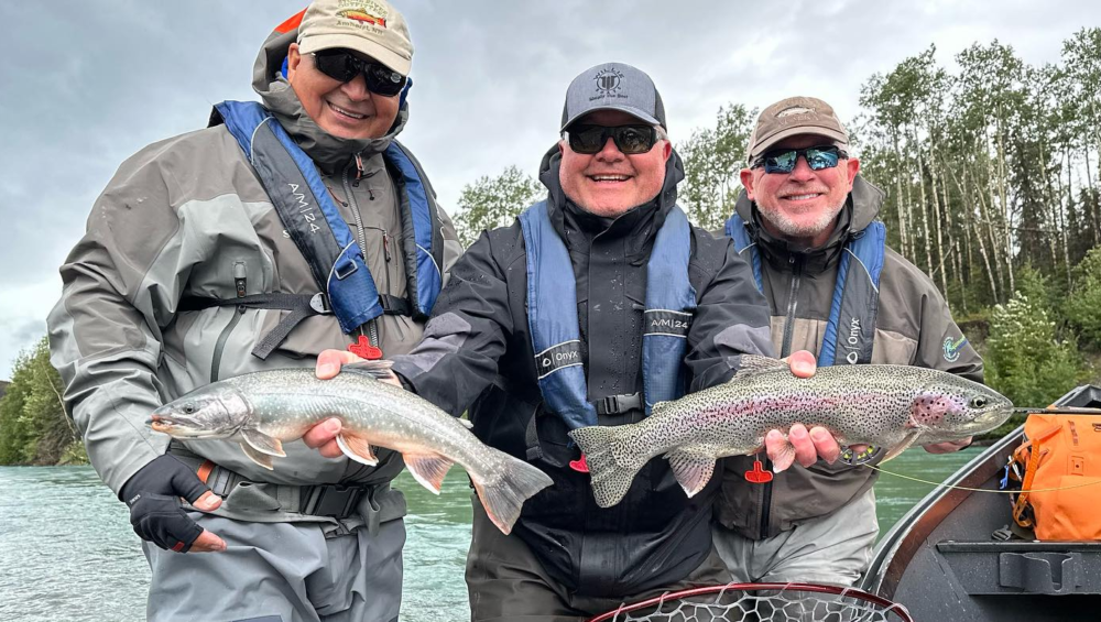 ishing guide Jason Lesmeister and fellow anglers holding fish on the Kenai River