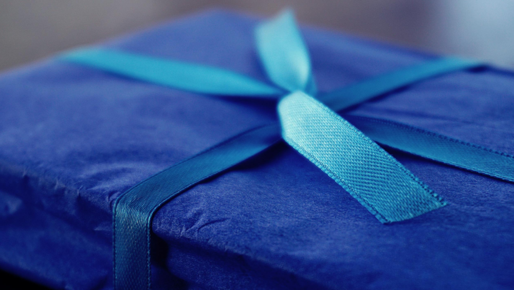 a present wrapped in blue wrapping paper and a ribbon