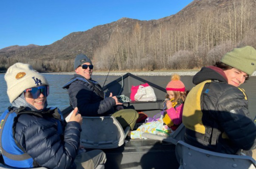 a family is on a boat in the Kenai River