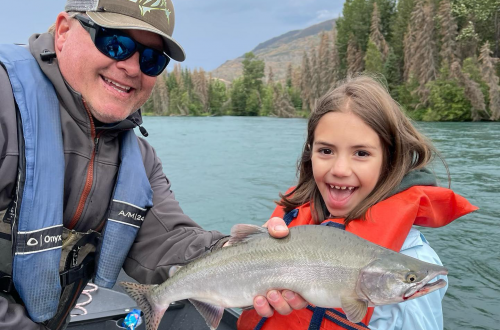 a girl holding a fish with fishing guide Jason Lesmeister