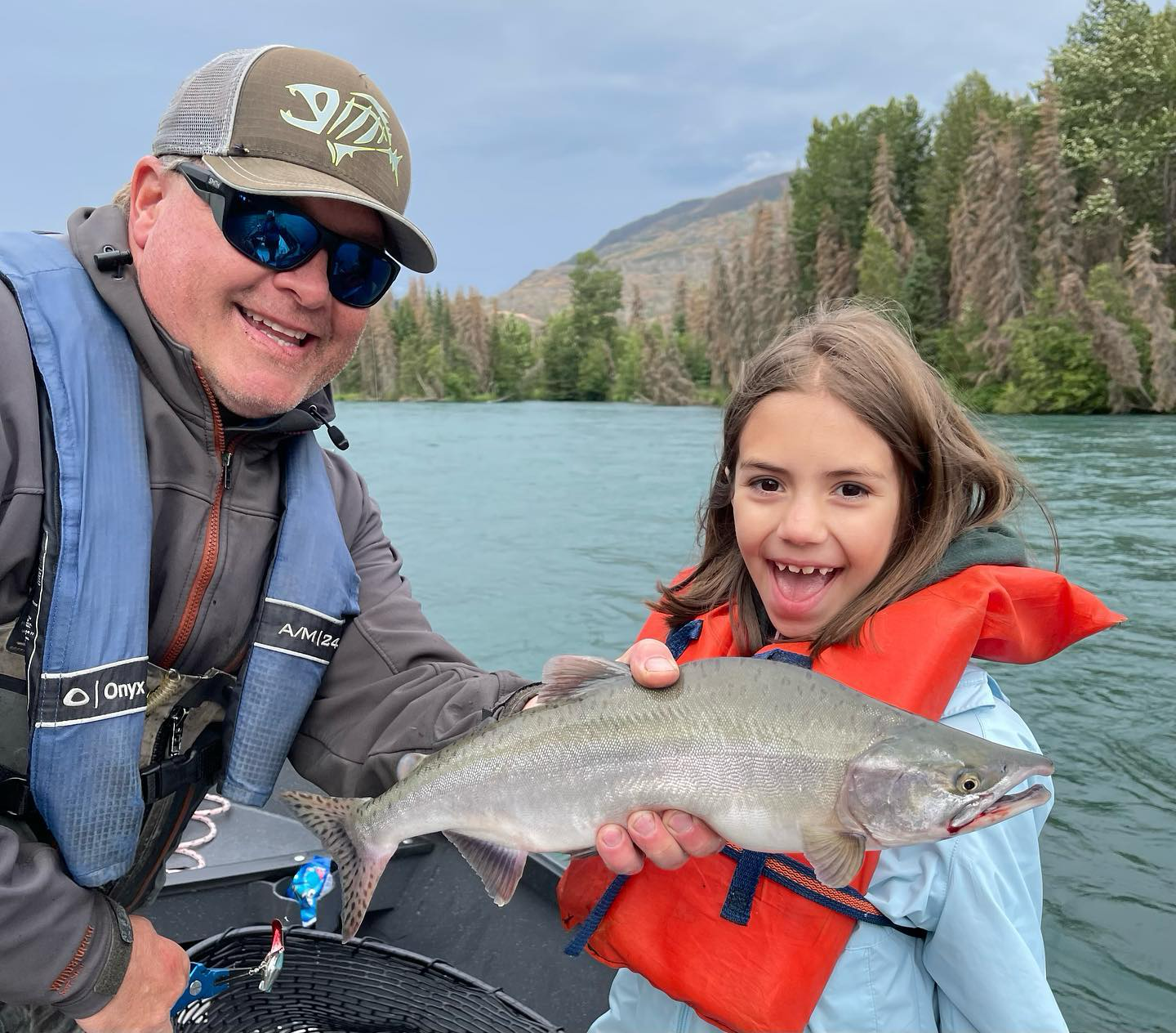 a girl holding a fish with fishing guide Jason Lesmeister