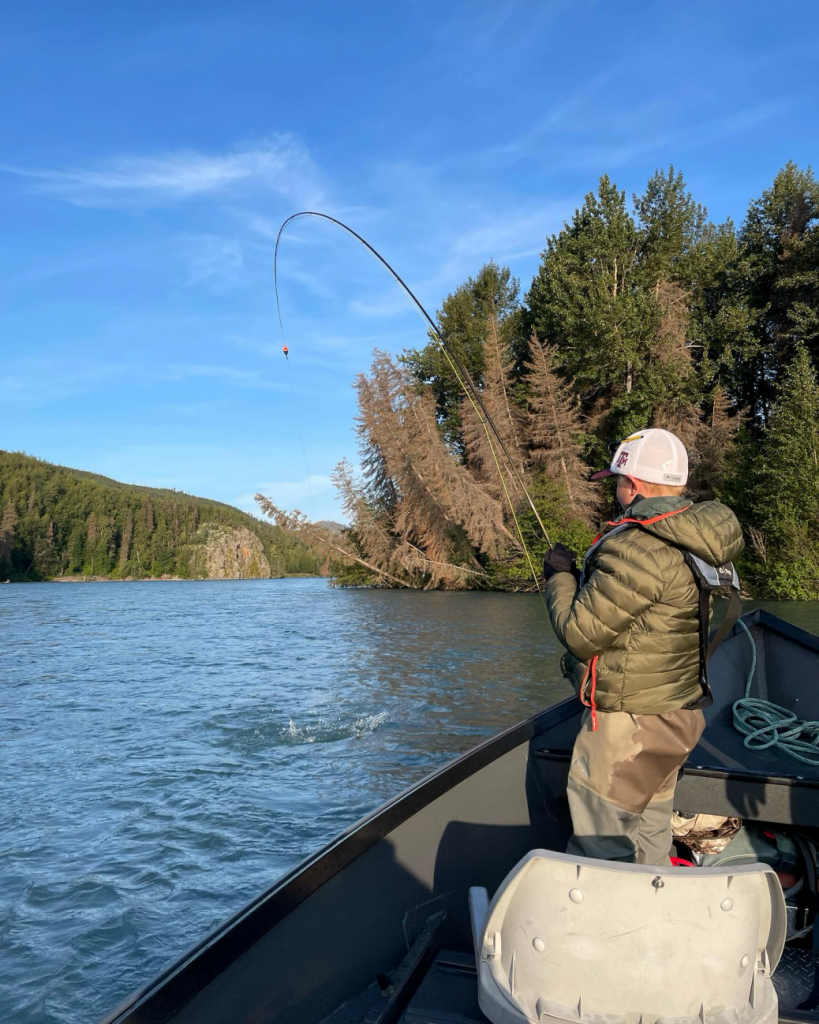 An angler fishing from a drift boat on the Kenai River.