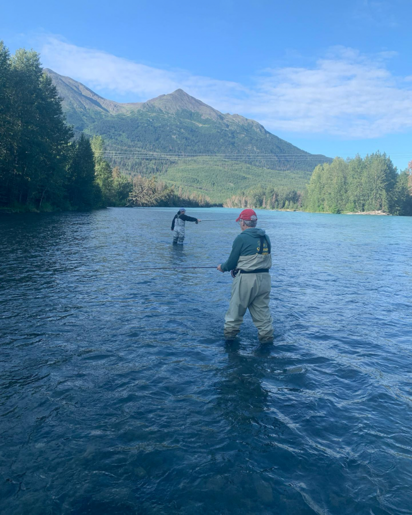 Anglers fishing on the Kenai River with a beautiful blue glow.