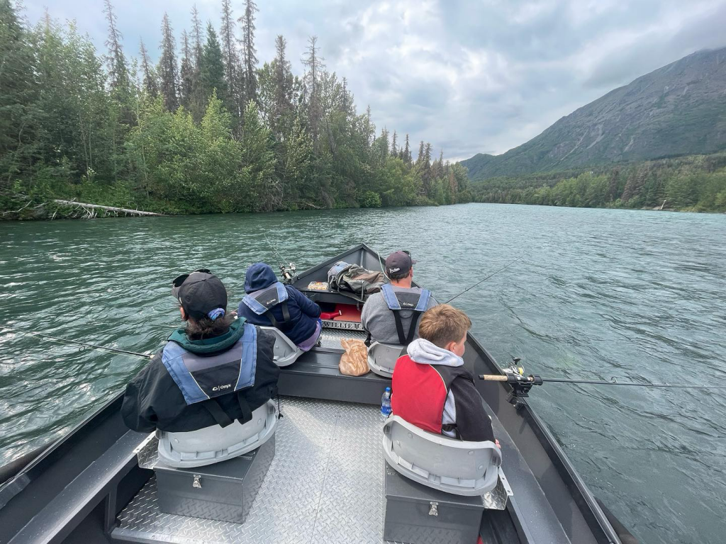 Anglers fishing from a drift boat equipped with high-quality fishing equipment.