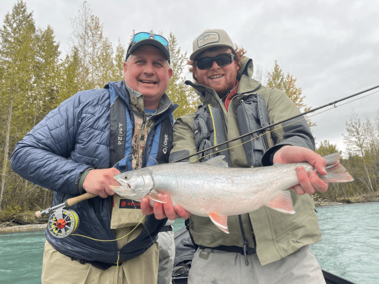 A fly fishing guide showing a person how to cast.